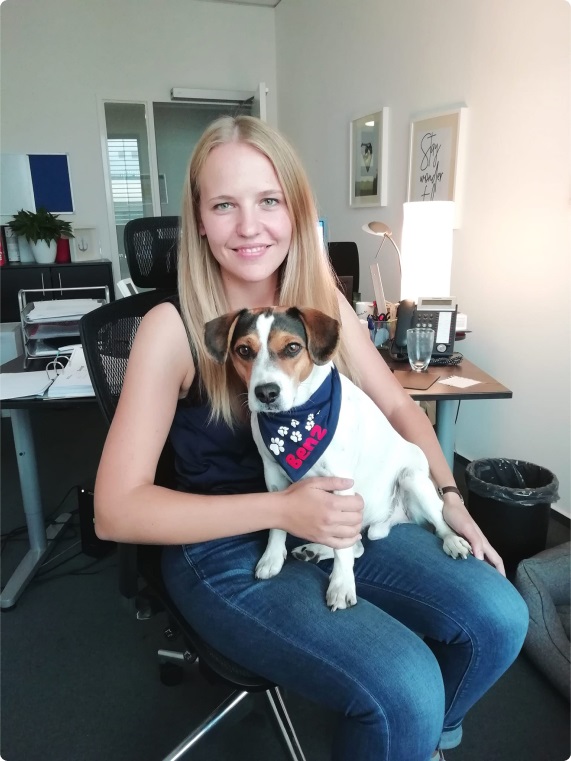 Smiling Woman with a cute dog on her lap