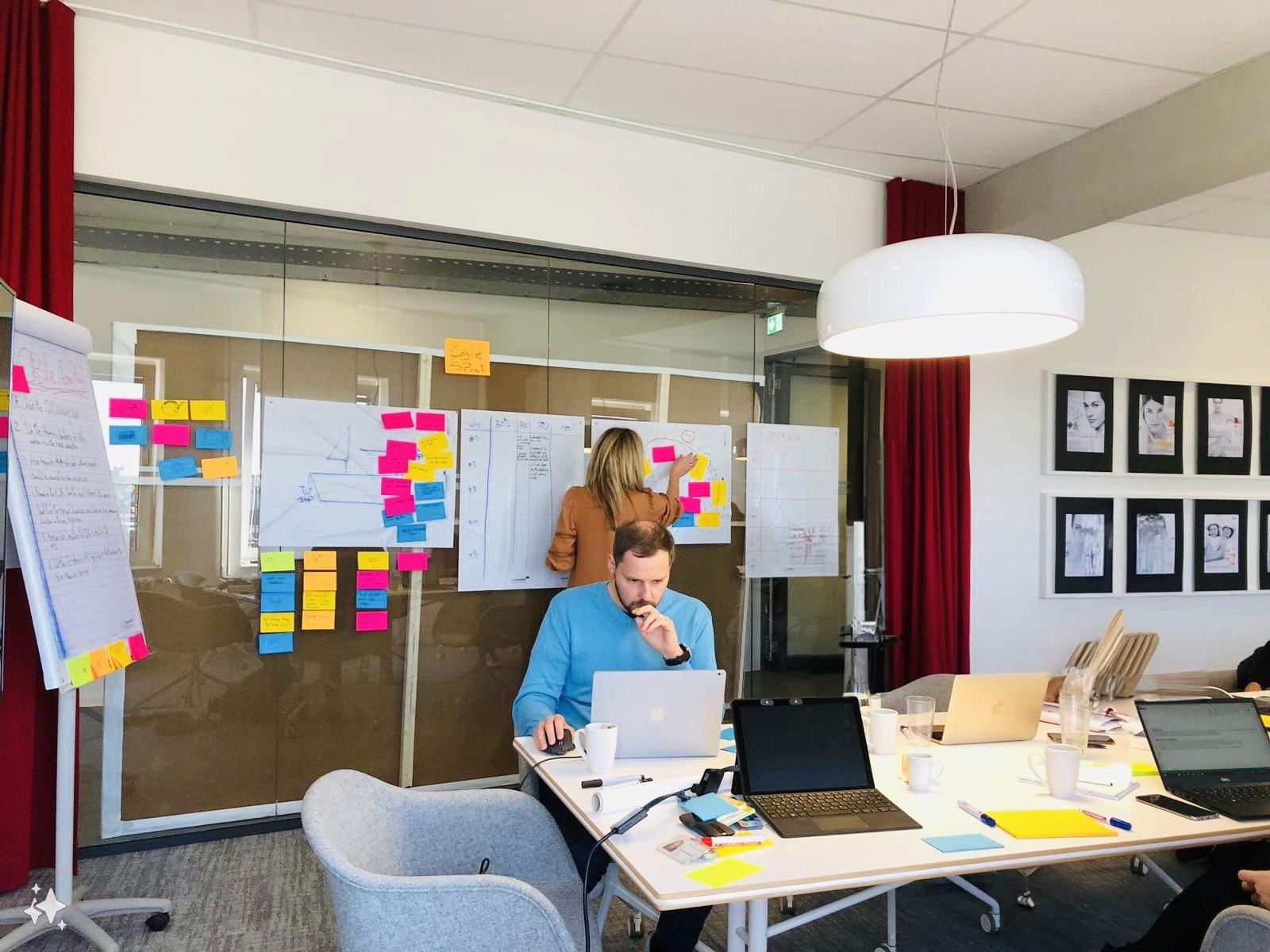 Modern office space where two people are working.