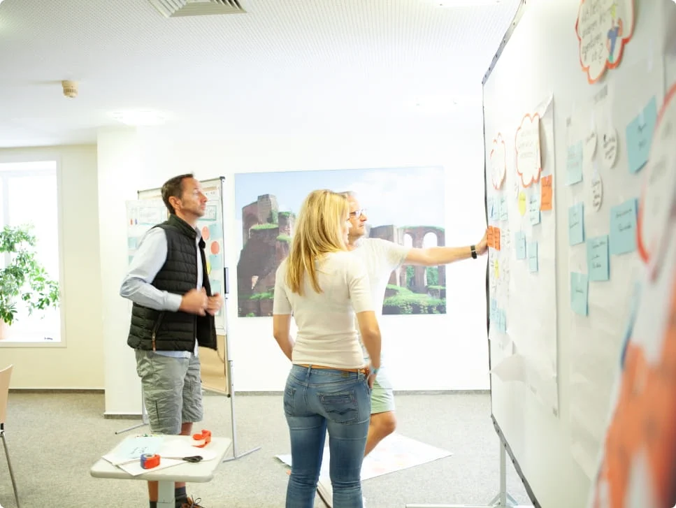 Three people who are brainstorming together