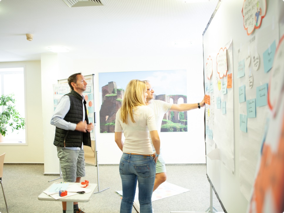 Three people who are brainstorming together