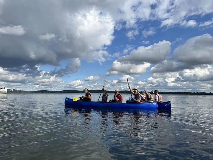 Canvas Reply team in canoes on the water